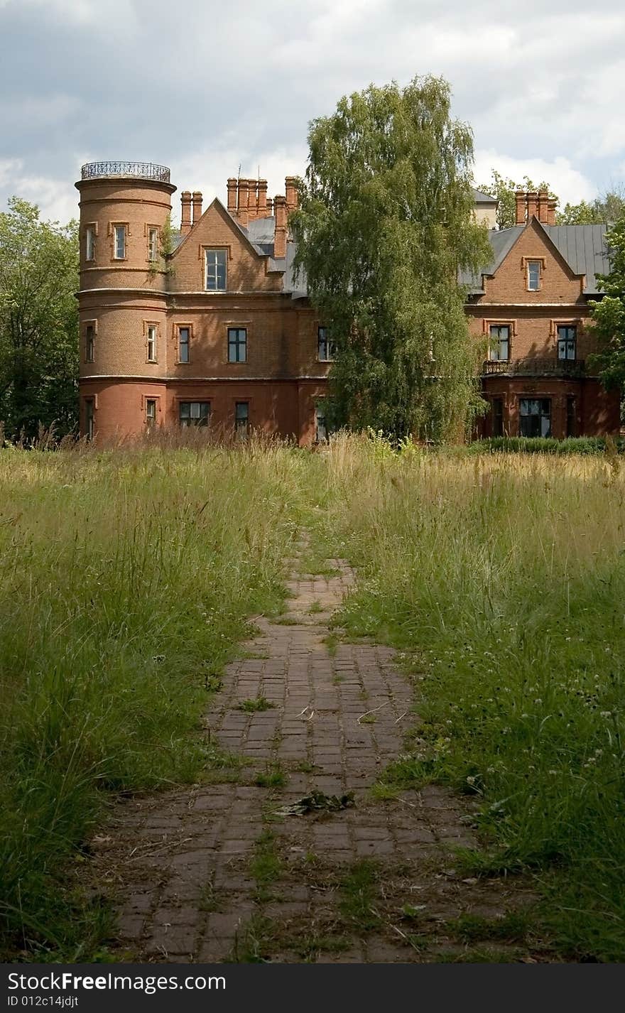 Abandoned old castle, ruins, footpath, green grass