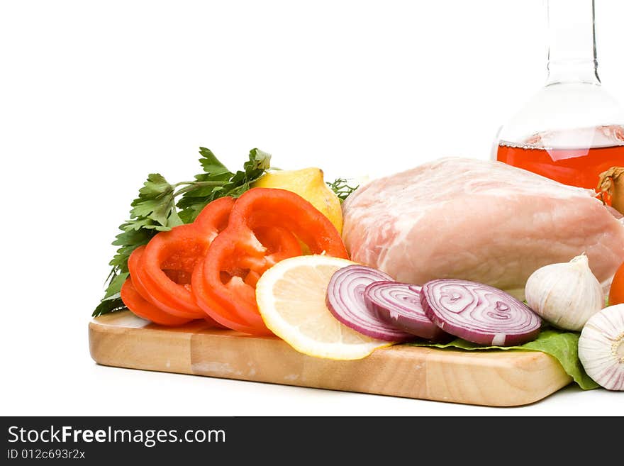 Fresh meat with vegetables on a white background. Close up.