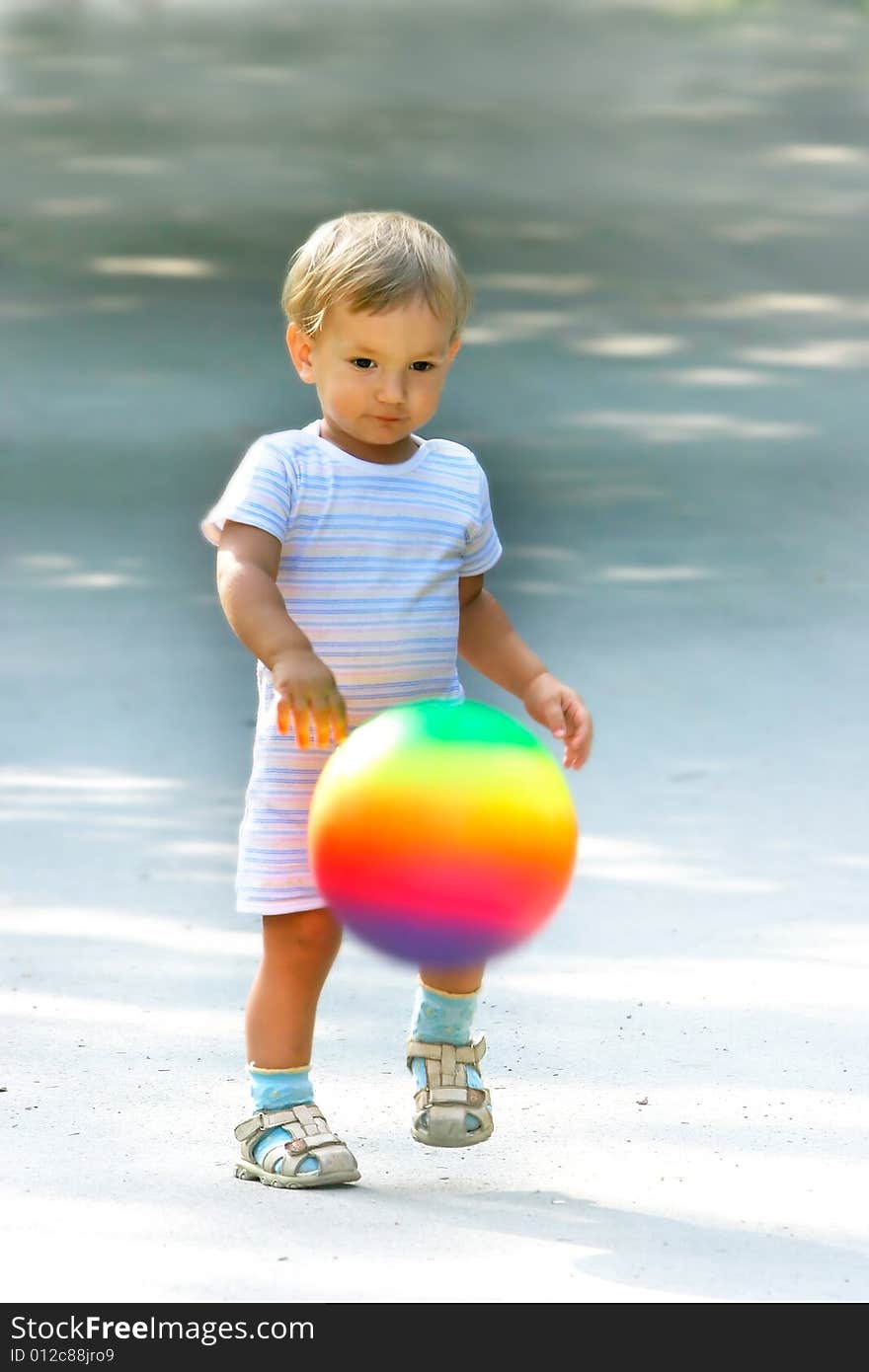 Boy with colorful ball on blurred background