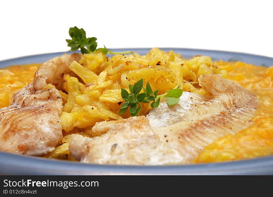 Alaska pollock on thin fries with delicious mango sauce arranged on a blue plate. Isolated on white background. Alaska pollock on thin fries with delicious mango sauce arranged on a blue plate. Isolated on white background.