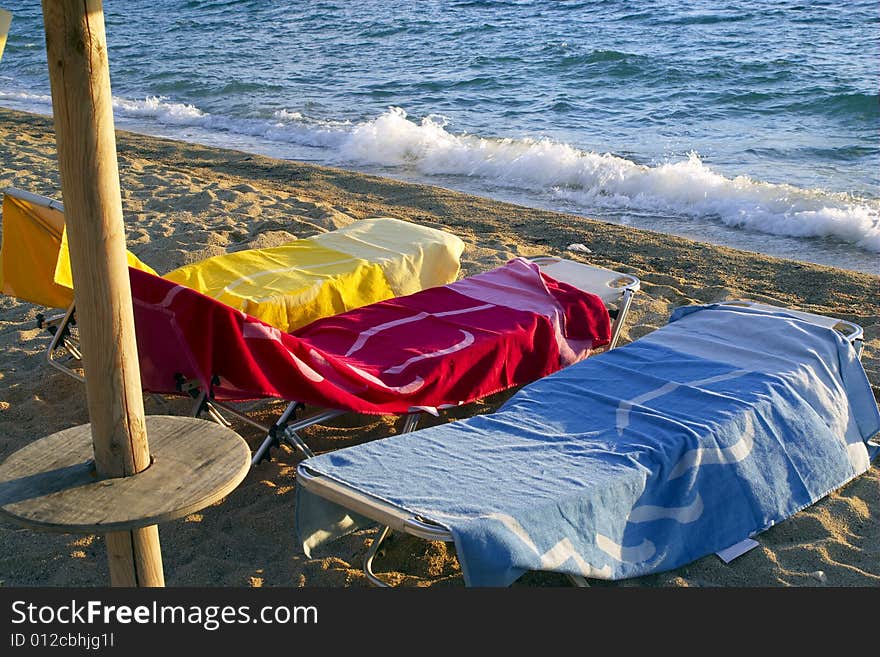 Three Towels On The Beach With Sea Waves