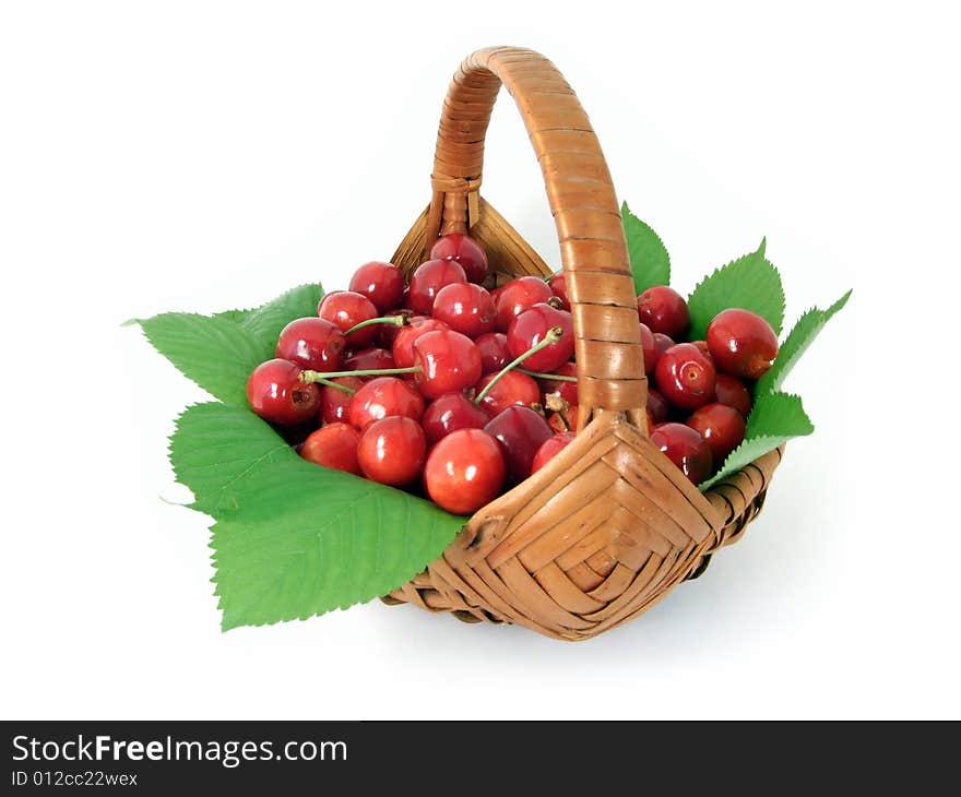 Cherries in a basket isolated on white background.