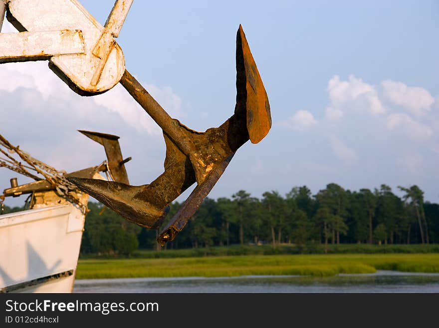 Anchor of a ship in port, with a blue sky background