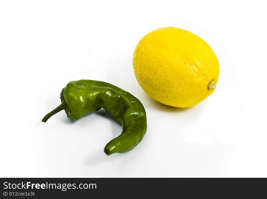 Green pepper and yellow lemon on white background. Green pepper and yellow lemon on white background