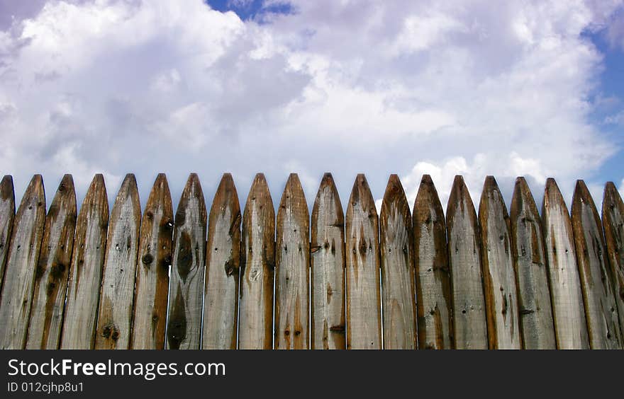 Wooden fence and clouds