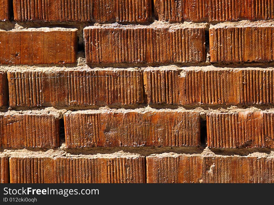 Wall with bright saturated orange bricks. Wall with bright saturated orange bricks