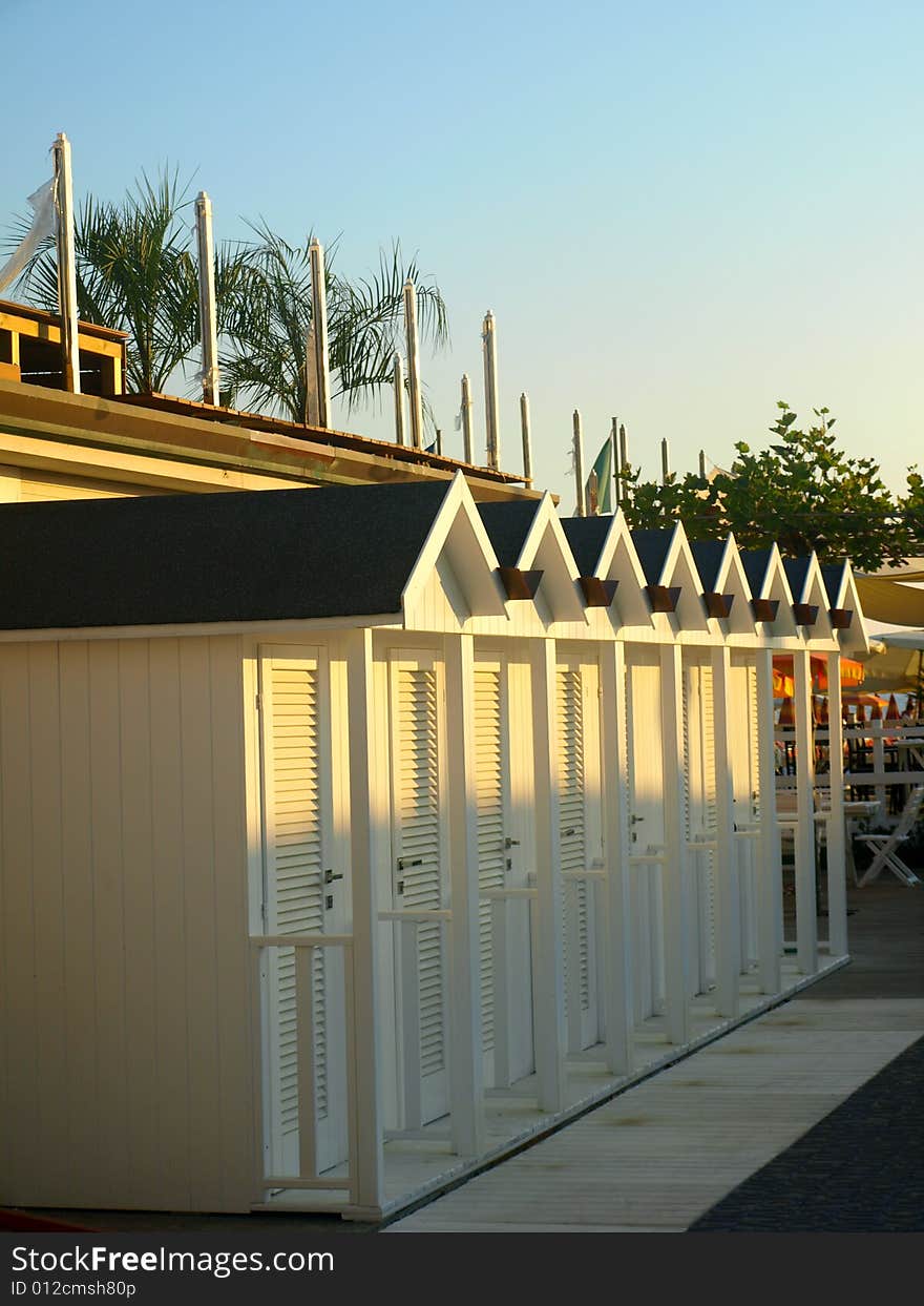 A good shot of a file of white beach huts