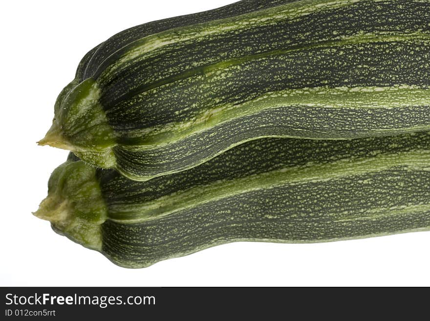 A single zucchini on a mirror