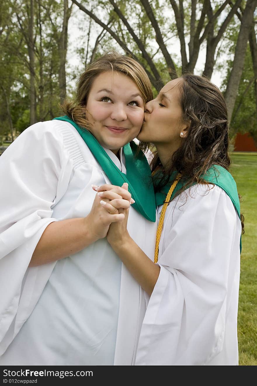 Two happy graduates wish each other luck in the future. Two happy graduates wish each other luck in the future.