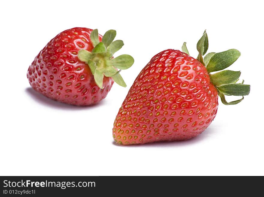 Two ripe strawberries on white background