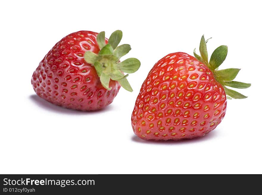 Two ripe strawberries on white background