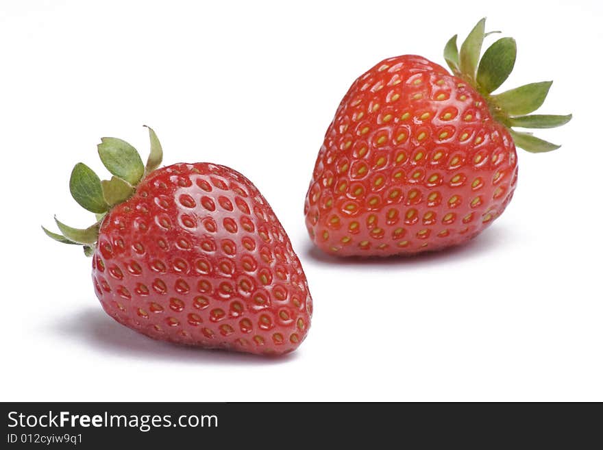 Two ripe strawberries on white background