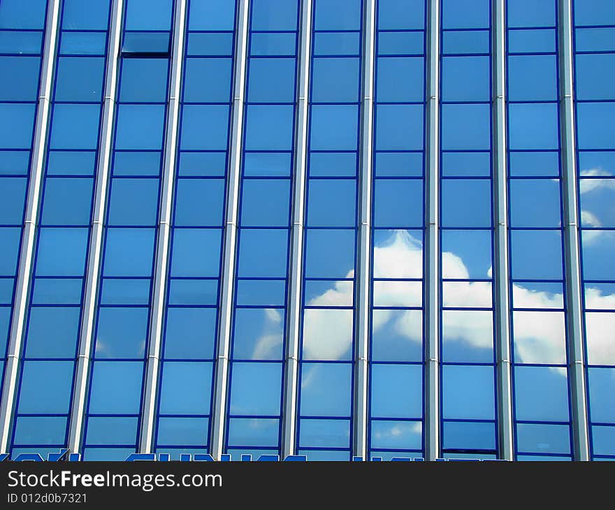 Modern city building. Construction from glass and metal. Dark blue sky is reflected in glass. Modern city building. Construction from glass and metal. Dark blue sky is reflected in glass.