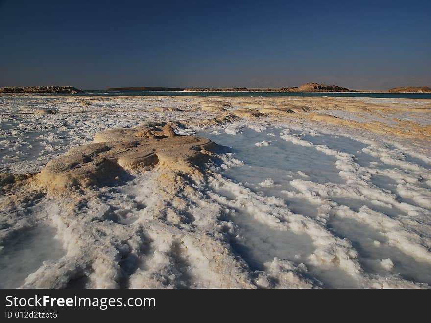 Salt on dead sea in the rays of sunset by evening