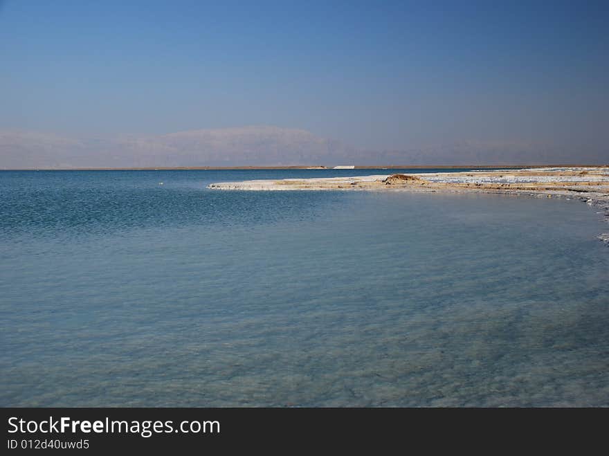 Salt on dead sea in the rays of sunset by evening