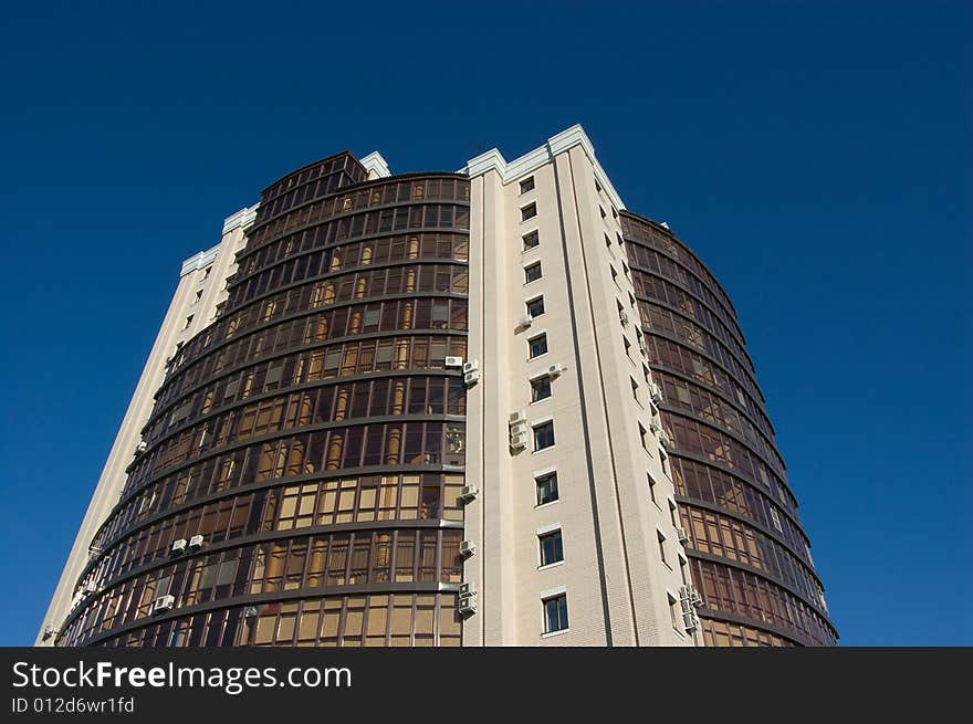 High modern office building with blue sky background