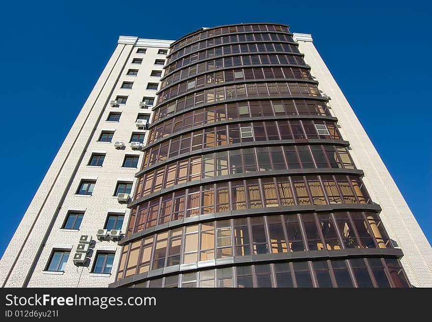 High modern office building with blue sky background