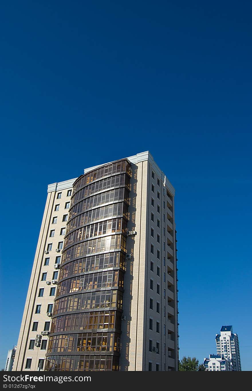 High modern buildings on blue sky - close and far away. High modern buildings on blue sky - close and far away