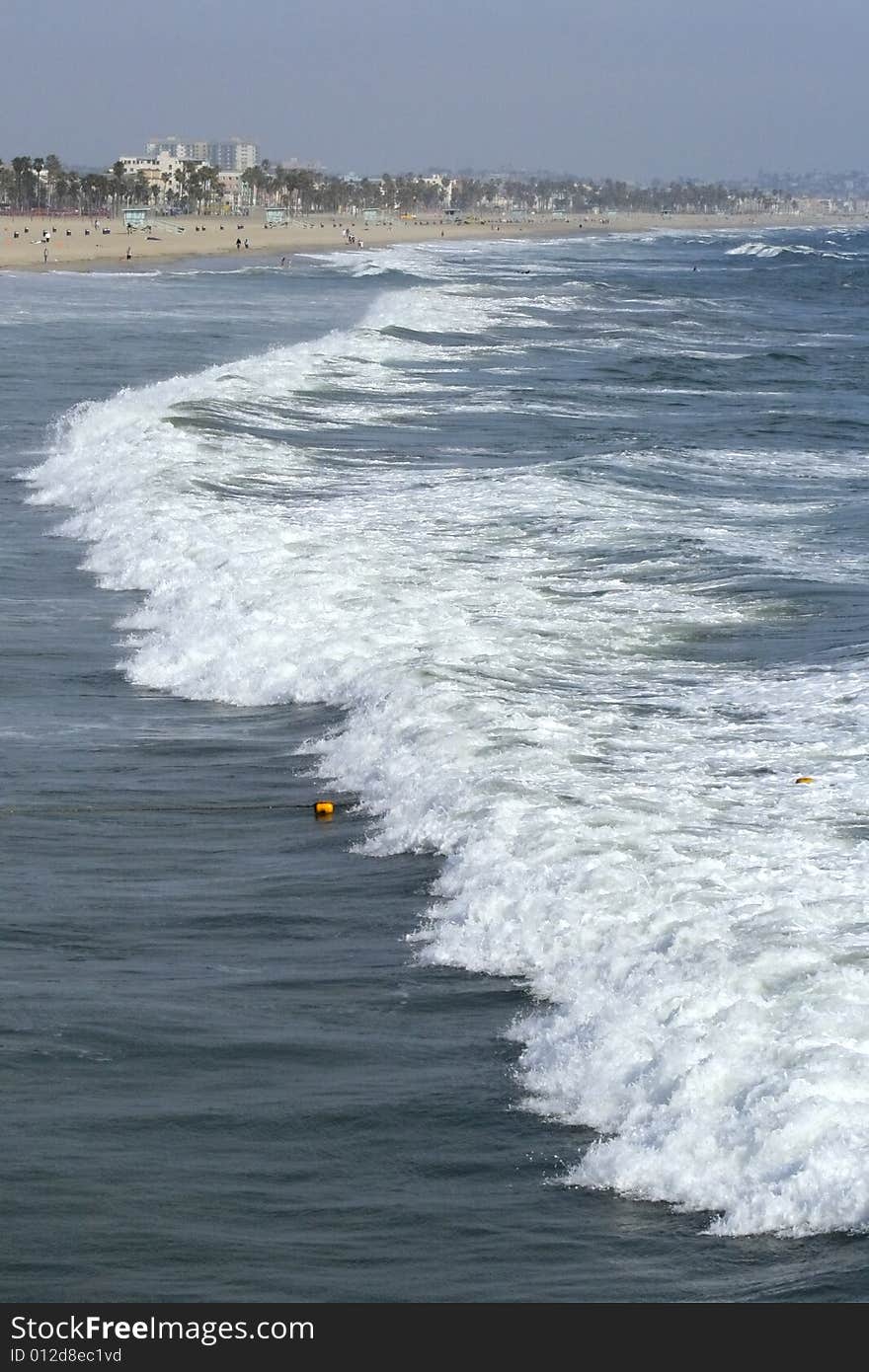 Waves coming ashore on sunny afternoon at Santa Monica Beach in California. Waves coming ashore on sunny afternoon at Santa Monica Beach in California.