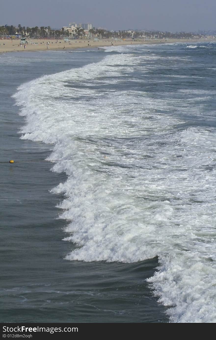 Waves coming ashore on sunny afternoon at Santa Monica Beach in California. Waves coming ashore on sunny afternoon at Santa Monica Beach in California.