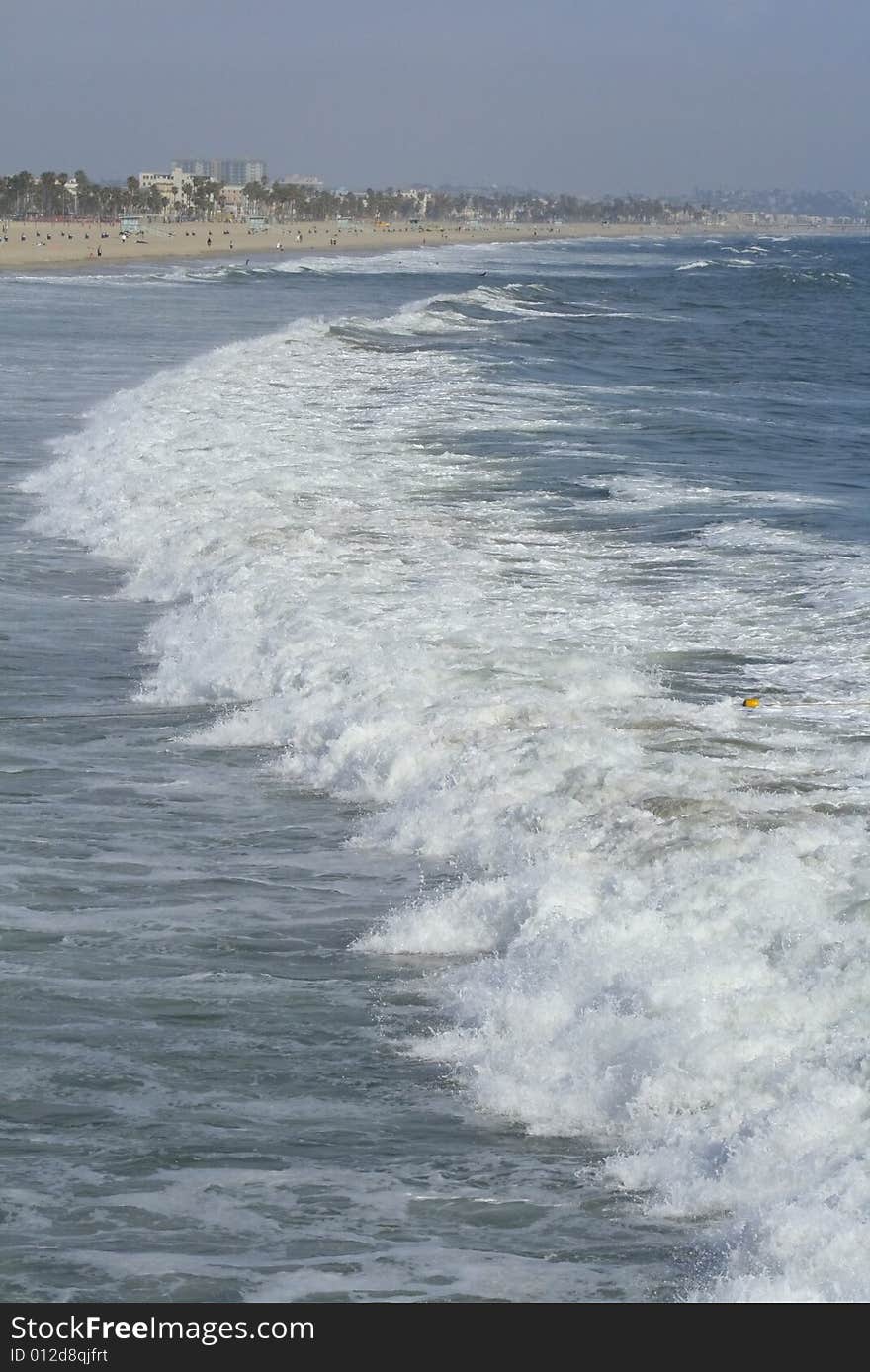 Waves coming ashore on sunny afternoon at Santa Monica Beach in California. Waves coming ashore on sunny afternoon at Santa Monica Beach in California.