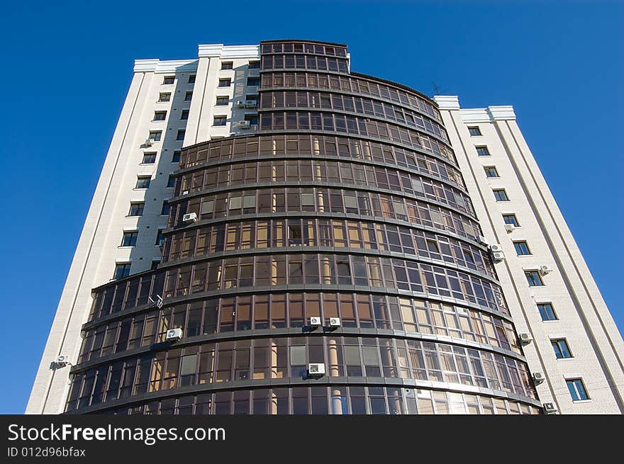 High modern office building with blue sky background