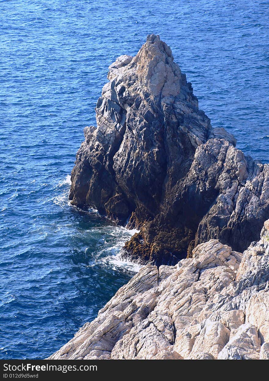 A beautiful shot of a rock in the Ligure sea. A beautiful shot of a rock in the Ligure sea