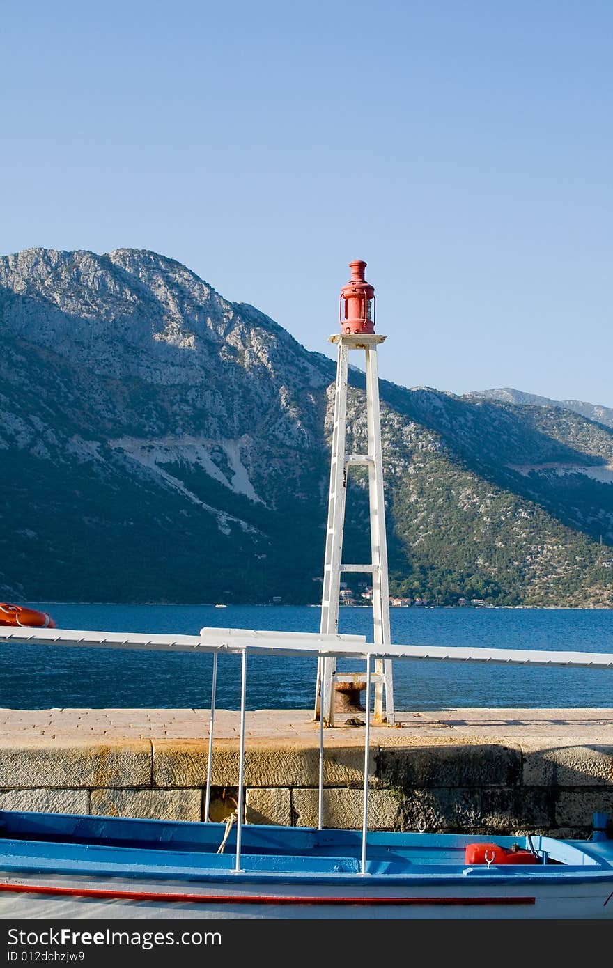 Small lighthouse and boat at dock