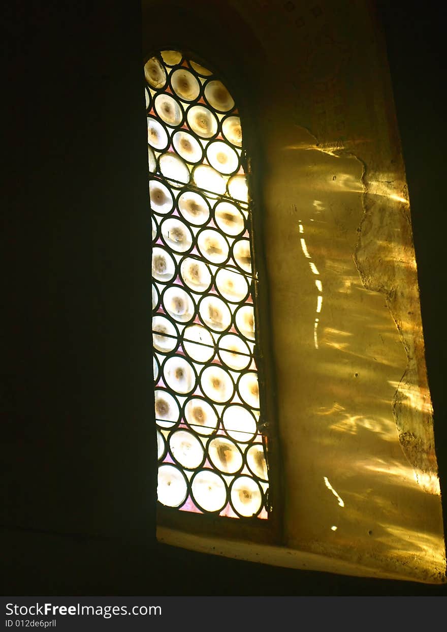 A suggestive shot of a stained-glass window in the Montesiepi hermitage in Tuscany