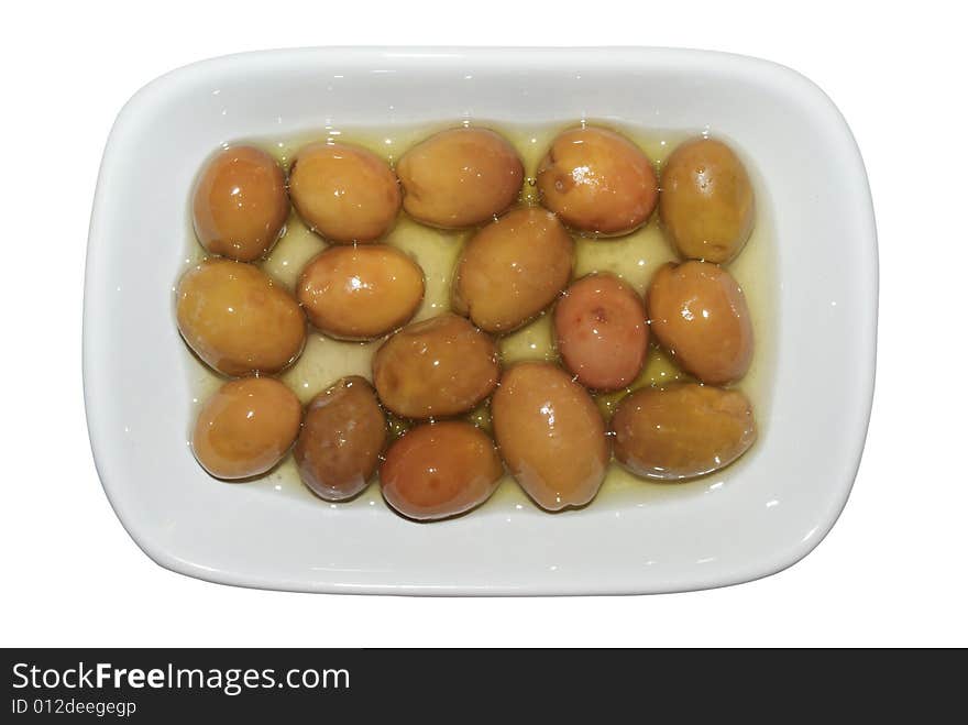 Green olives in a cup with olive oil