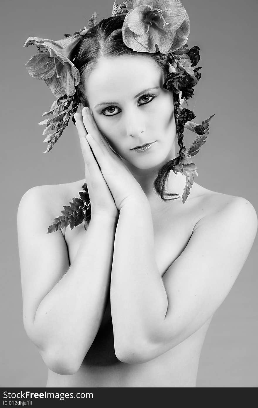 Young woman with big flowers in her hair. Young woman with big flowers in her hair