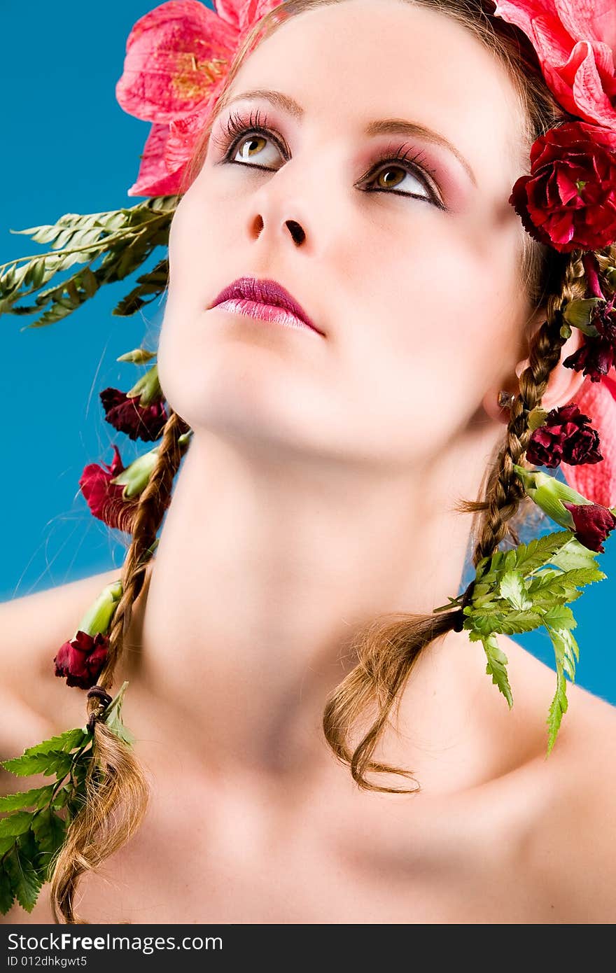 Young woman with big flowers in her hair. Young woman with big flowers in her hair