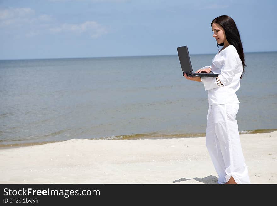 Attractive brunette woman relaxing on the beach. Attractive brunette woman relaxing on the beach