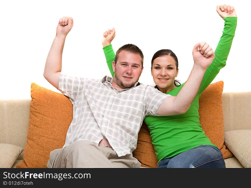 Happy couple sitting together on sofa. Happy couple sitting together on sofa