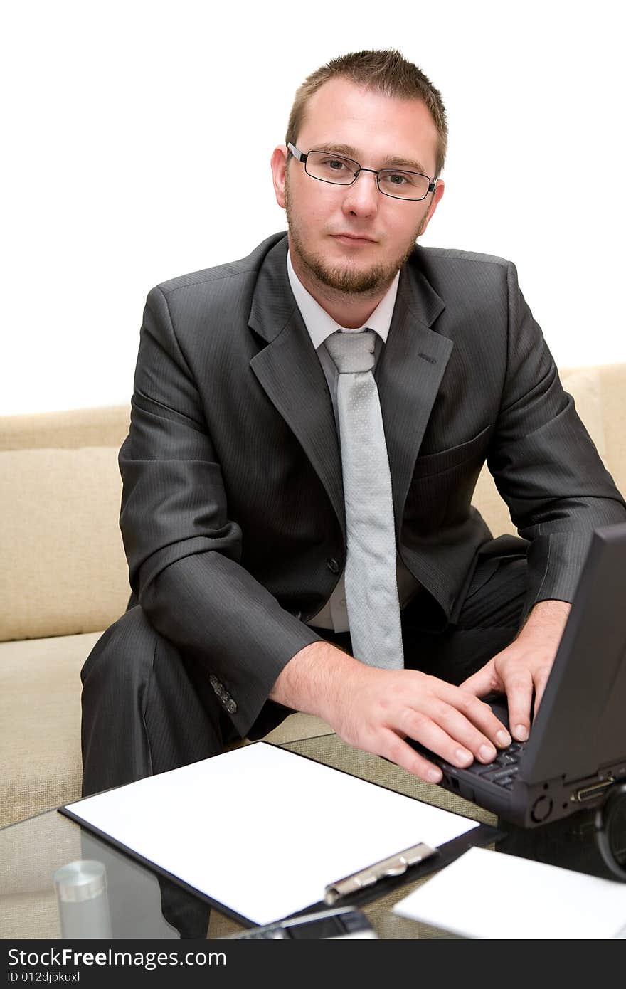 Happy man sitting on sofa with laptop. Happy man sitting on sofa with laptop