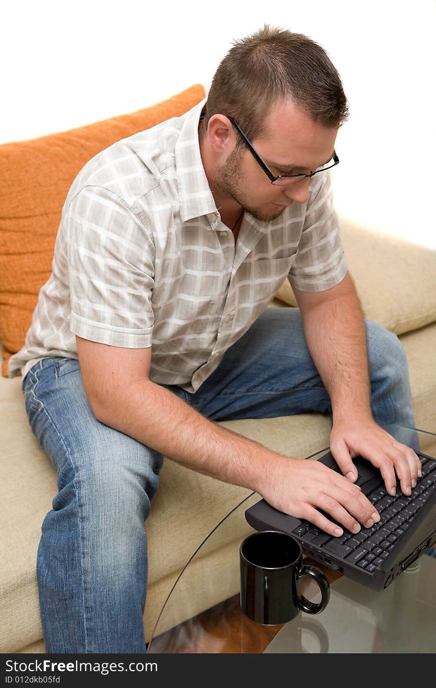 Happy man sitting on sofa with laptop. Happy man sitting on sofa with laptop