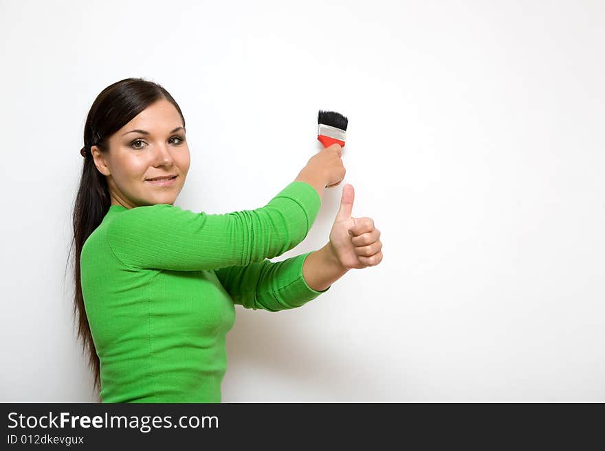 Casual brunette woman painting wall. Casual brunette woman painting wall