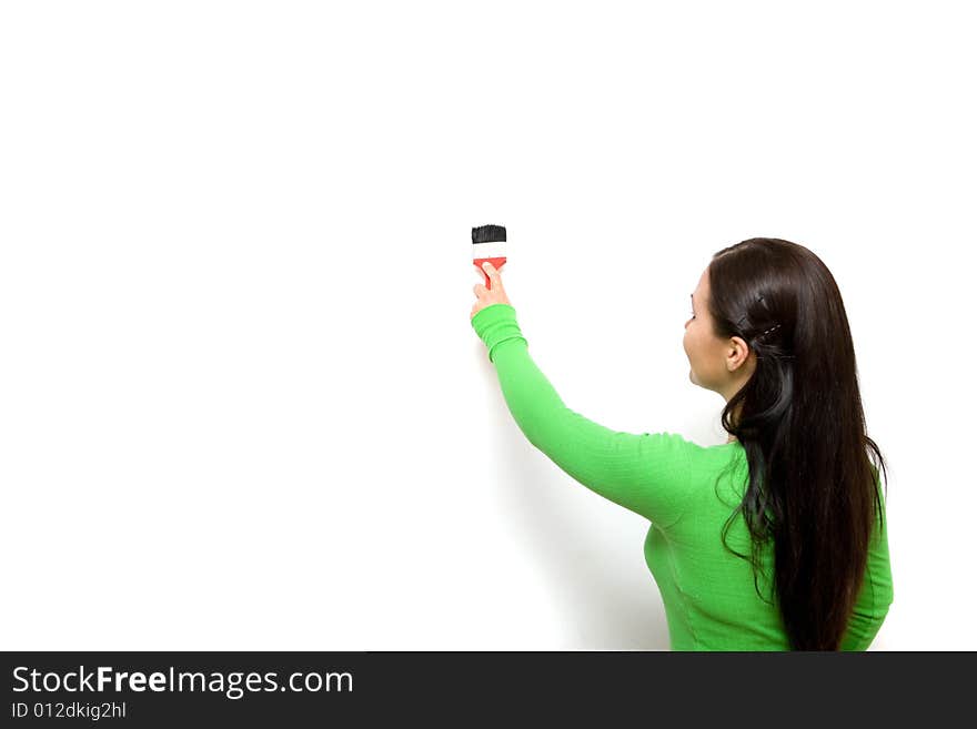 Casual brunette woman painting wall. Casual brunette woman painting wall