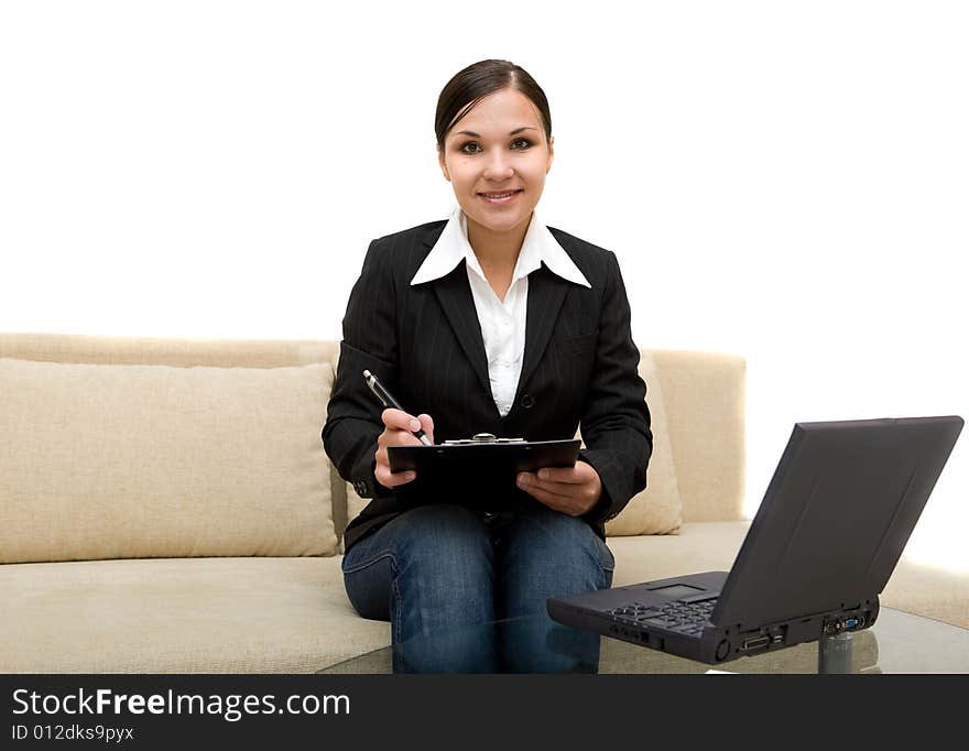 Attractive brunette woman on sofa with laptop. Attractive brunette woman on sofa with laptop