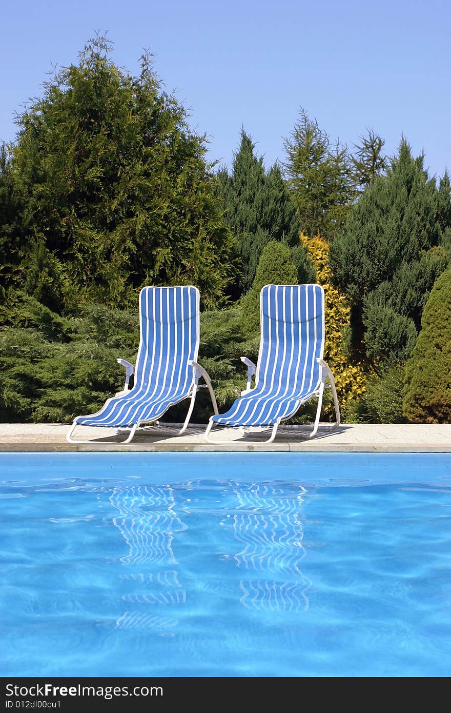 Two deckchairs at the pool. Two deckchairs at the pool