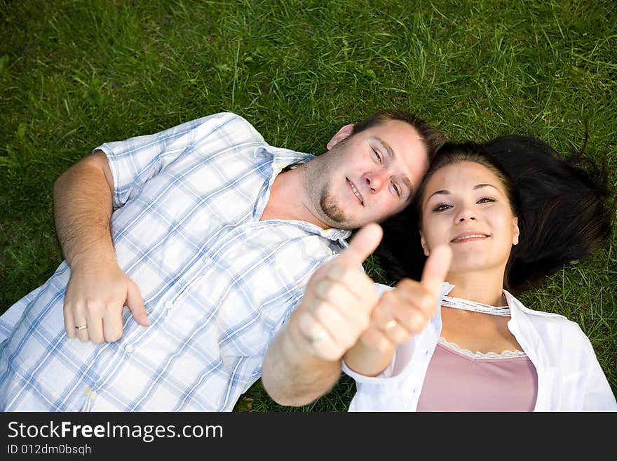 Happy couple lying on grass. Happy couple lying on grass