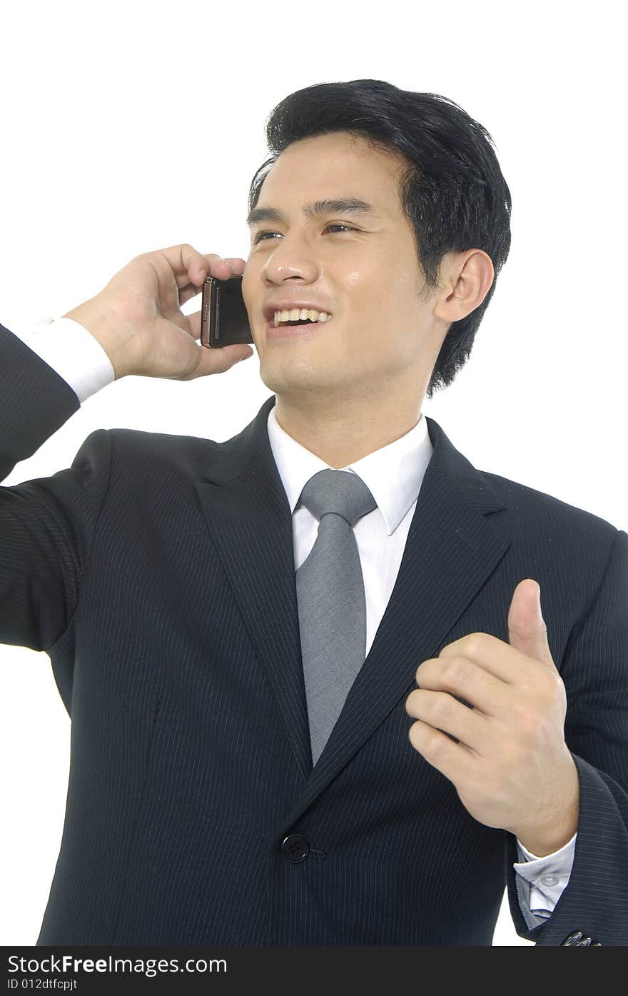 Man in suit on cell phone looking happy and laughing. Man in suit on cell phone looking happy and laughing