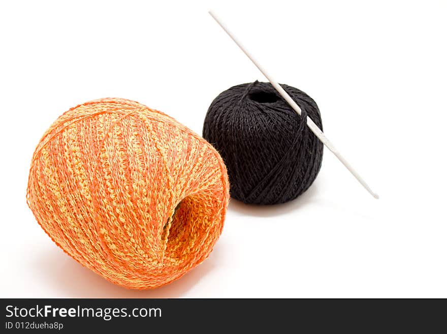 Two balls with crochet hook. Two balls with crochet hook