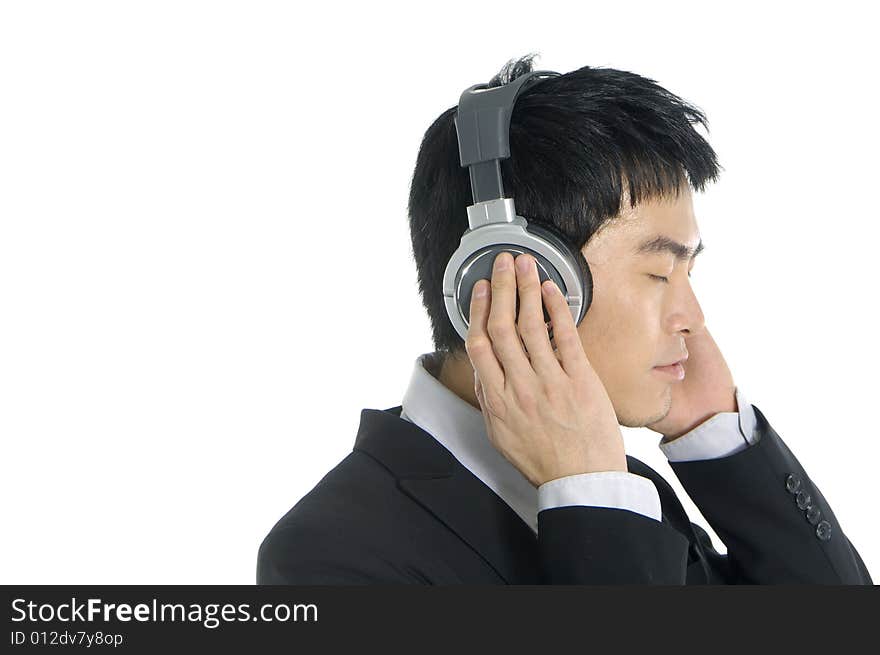 Business man listening to music, isolated in white background