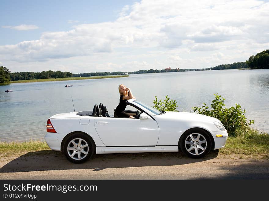 Portrait of the beautiful young girl with cabriolet