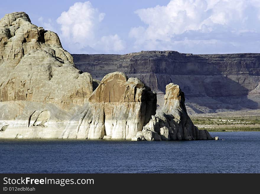 Rugged boulders protrude out of Lake Powell near the Arizona/Utah border. Lake Powell is a boating enthusiasts dream in the desert. Rugged boulders protrude out of Lake Powell near the Arizona/Utah border. Lake Powell is a boating enthusiasts dream in the desert.