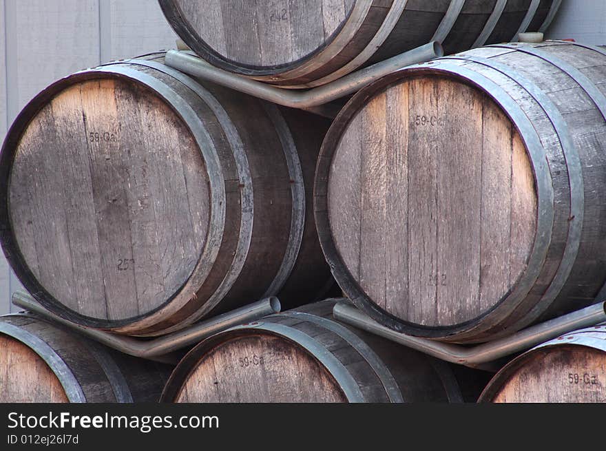 A stack of brown wooden wine barrels