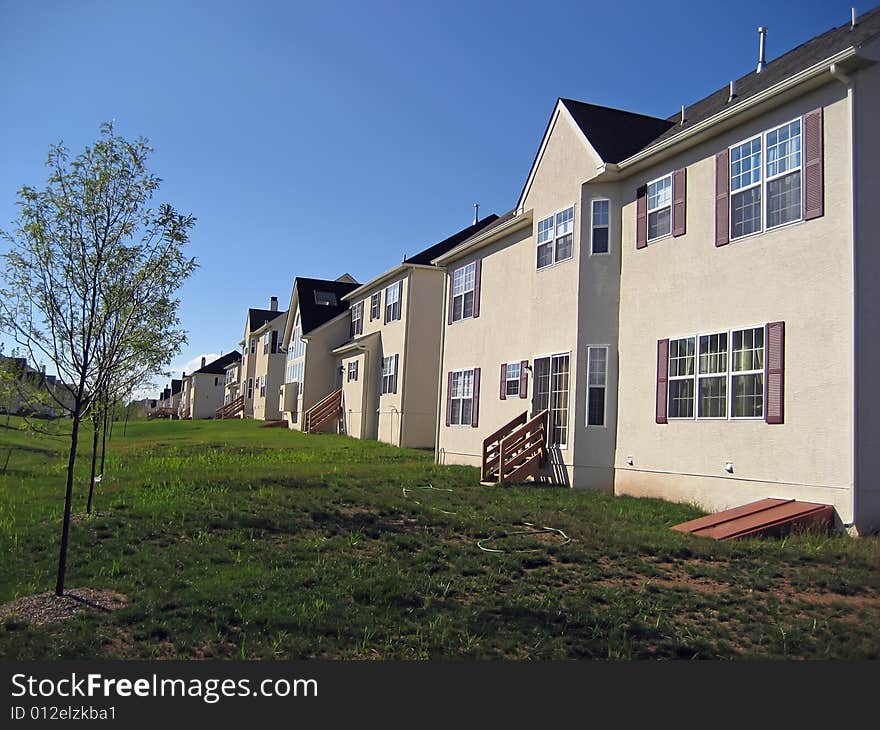 Backyards and rear entrances of upscale suburban homes. Backyards and rear entrances of upscale suburban homes.