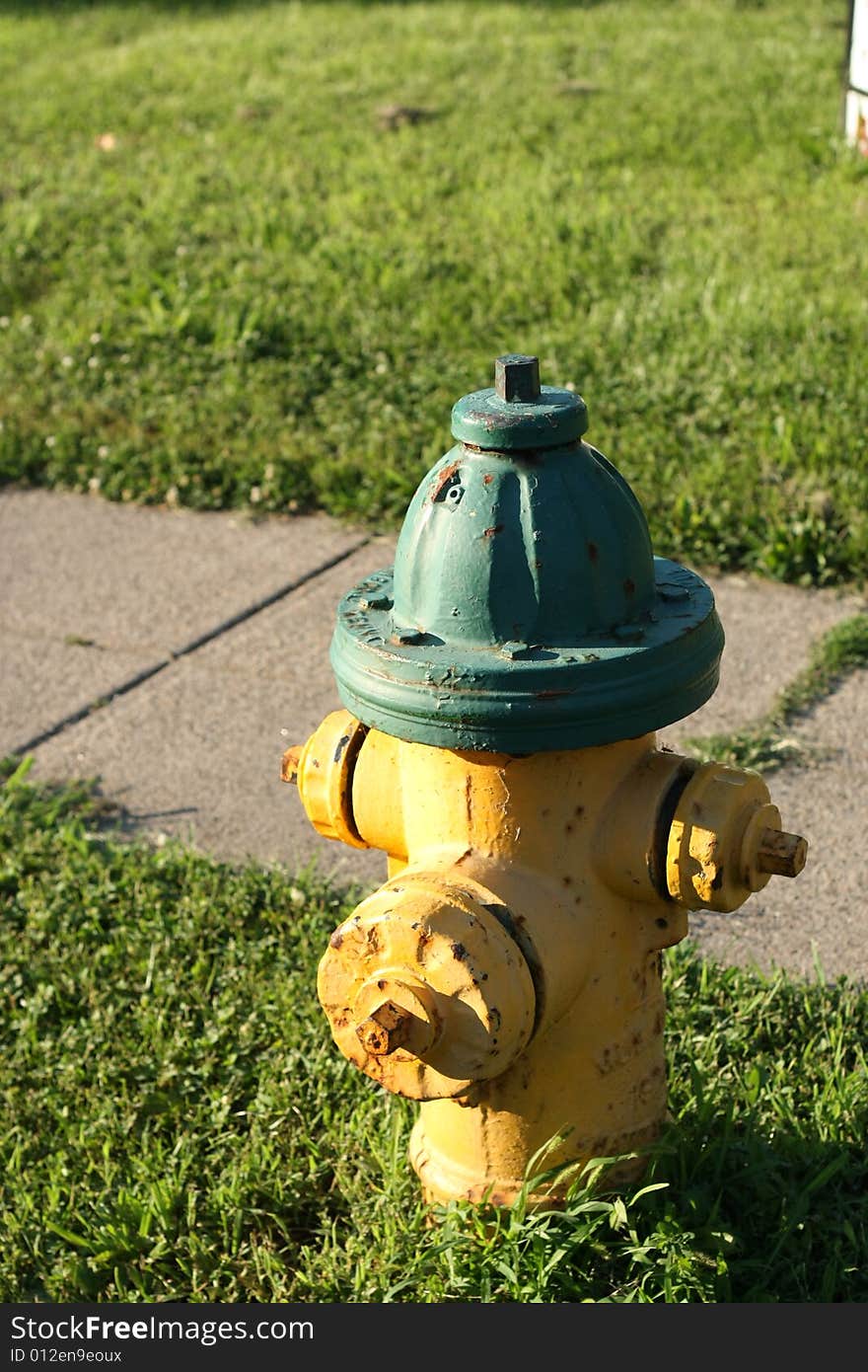 Yellow fire hydrant, Sidelit in summer in local neighborhood