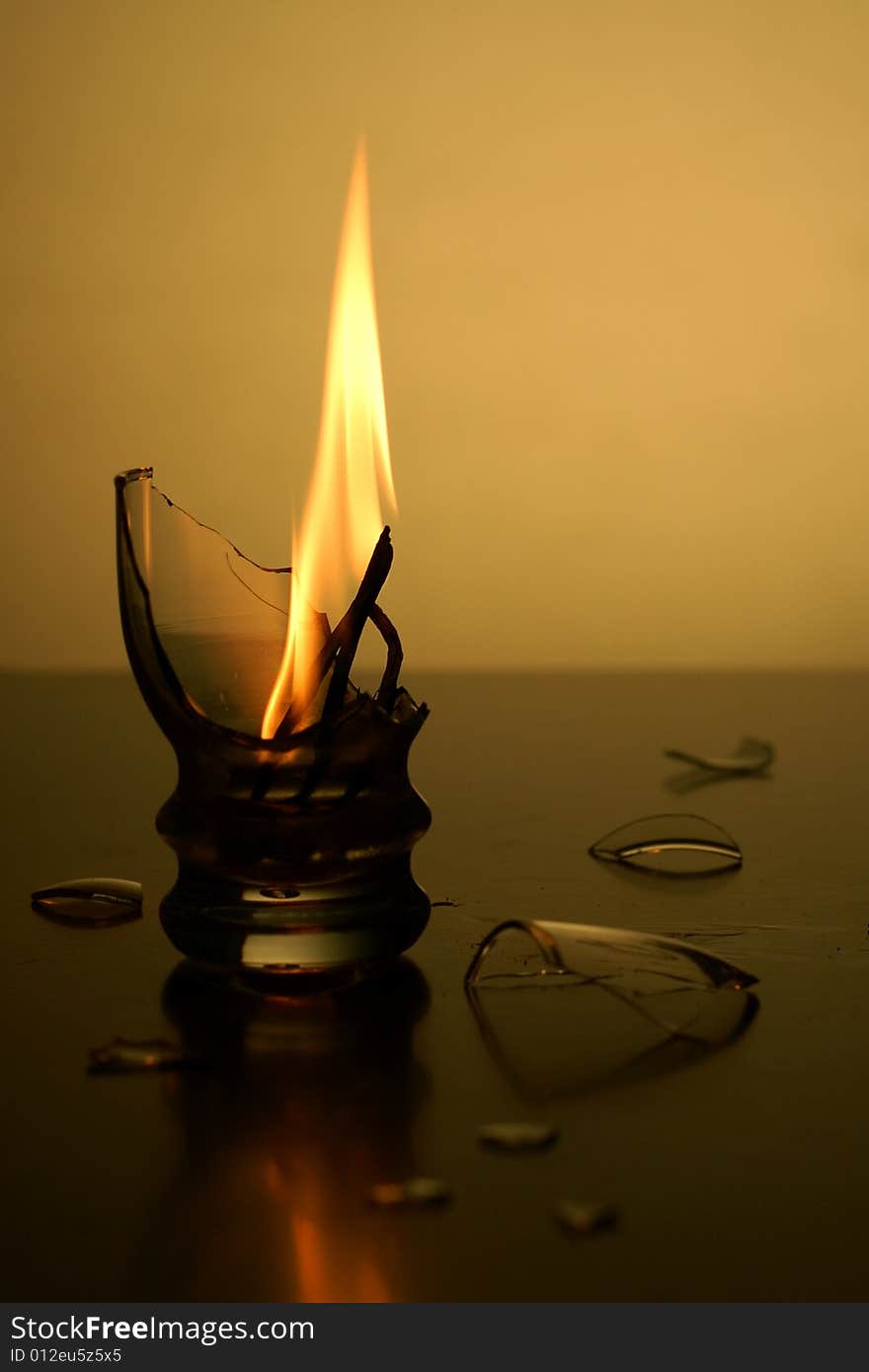 Flame in broken cup or matches are burning in cup